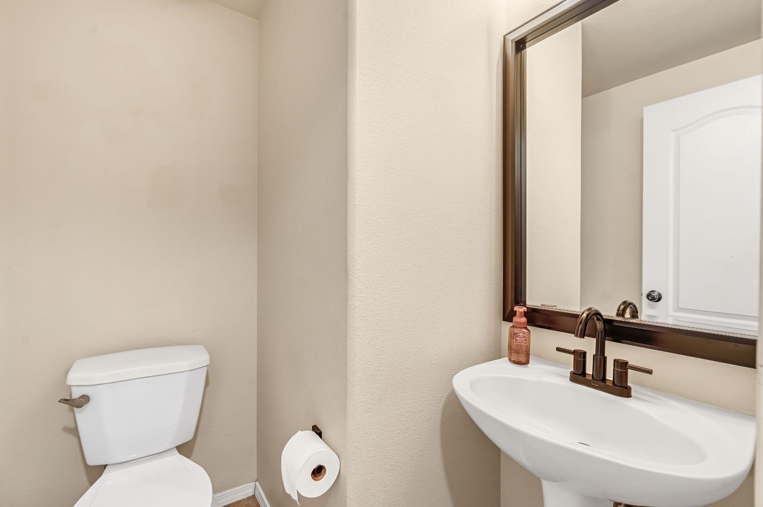 5629 North Citrus Lane Fresno, CA 93711 - Photo 28 of 35 a bathroom with a toilet sink and mirror