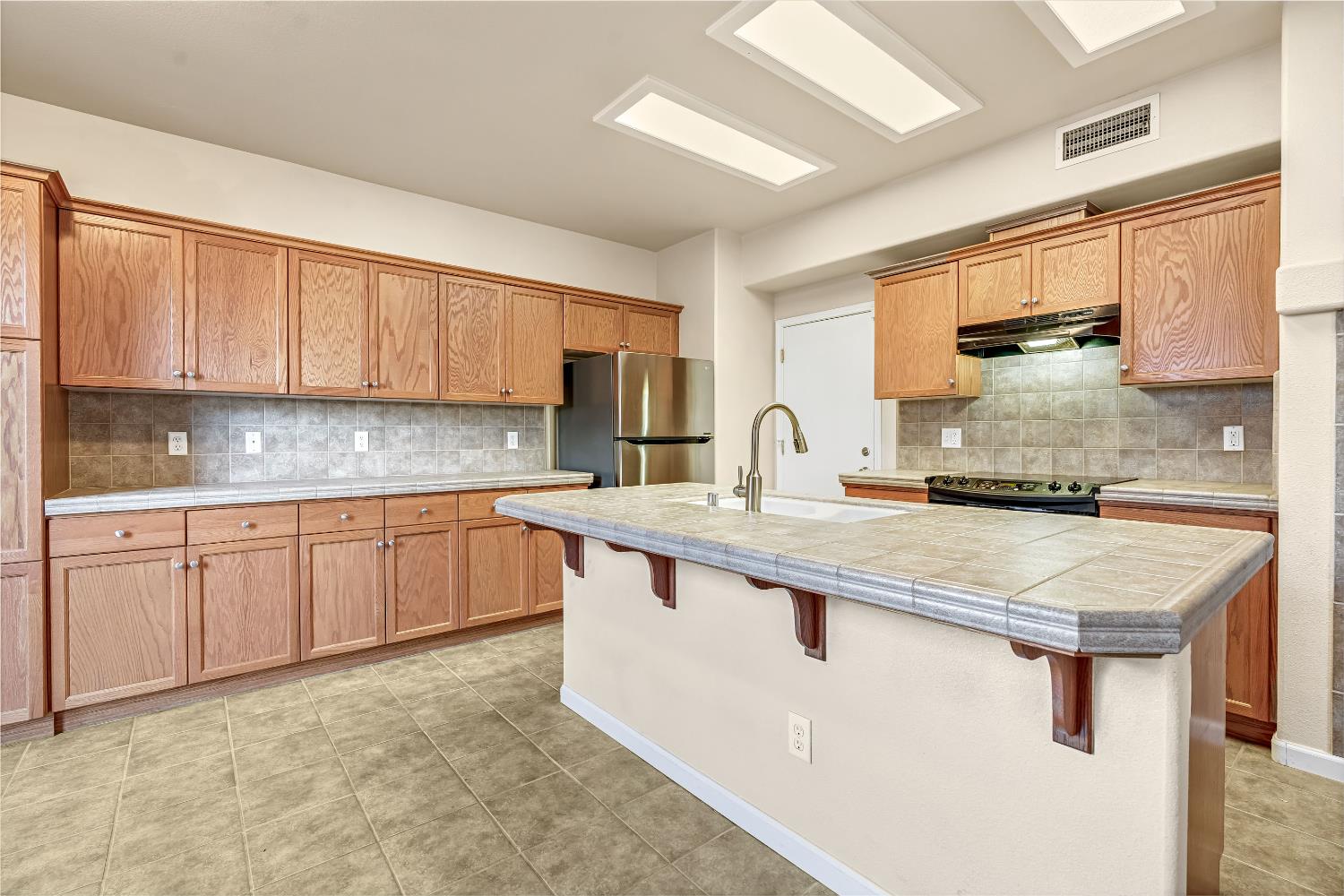 5629 North Citrus Lane Fresno, CA 93711 - Photo 9 of 35 a kitchen with stainless steel appliances granite countertop a sink stove and cabinets
