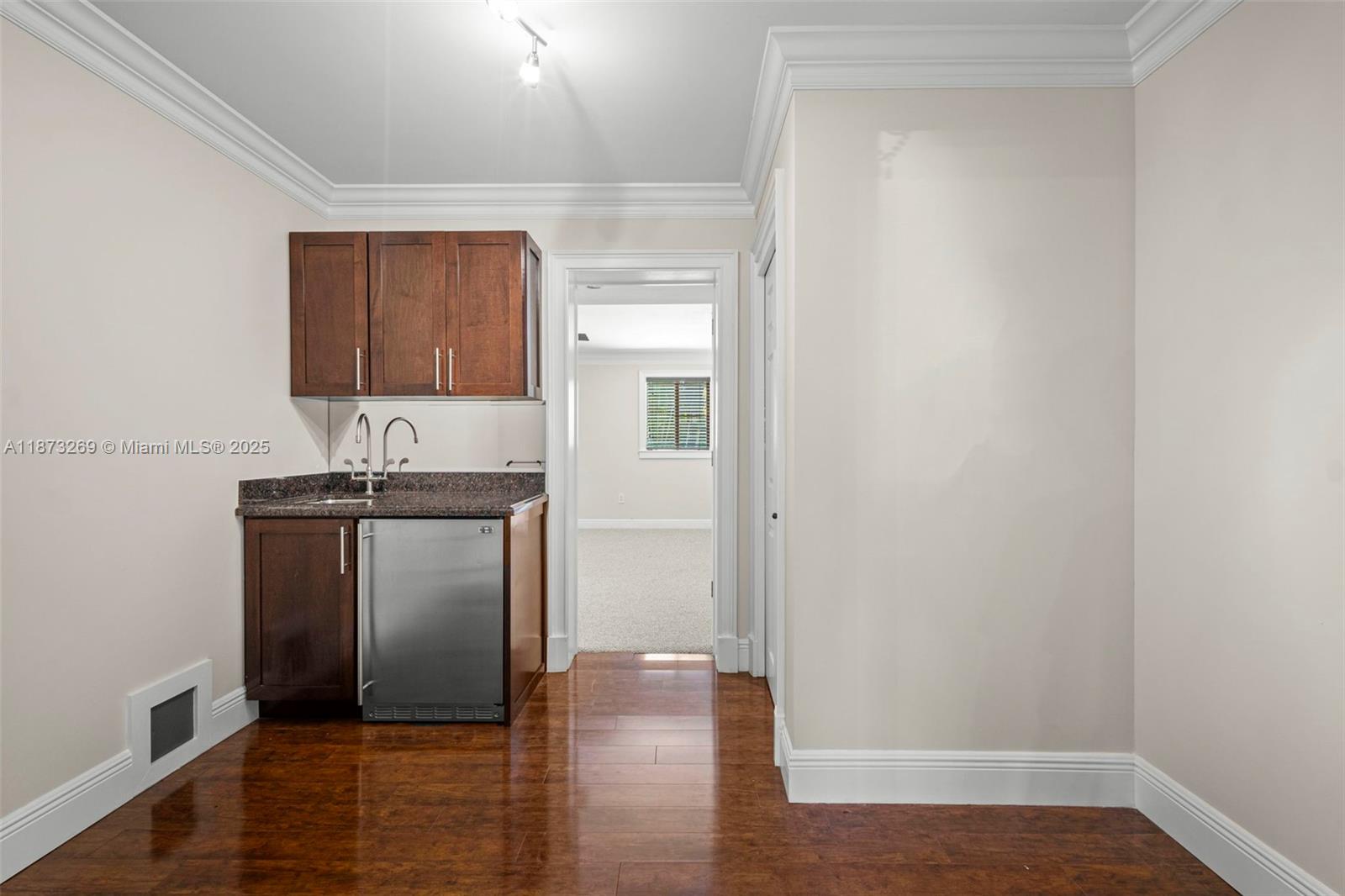 8260 Southwest 95th Street Miami, FL 33156 - Photo 17 of 50 a kitchen with granite countertop a refrigerator and a hard wood floor