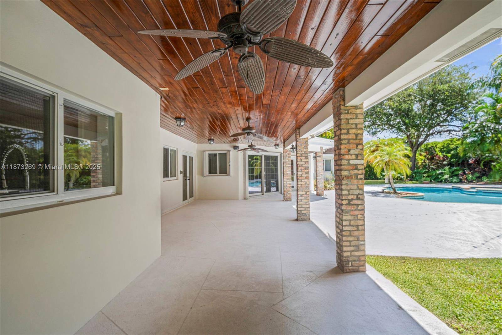 8260 Southwest 95th Street Miami, FL 33156 - Photo 37 of 50 a view of a porch with couches and wooden fence