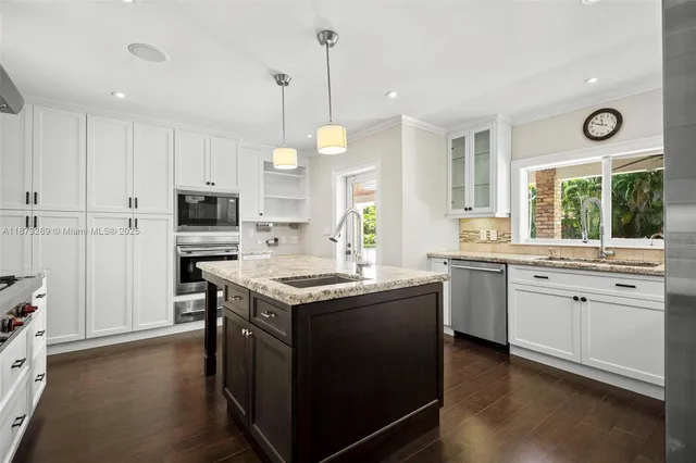 a kitchen with a sink stove and cabinets