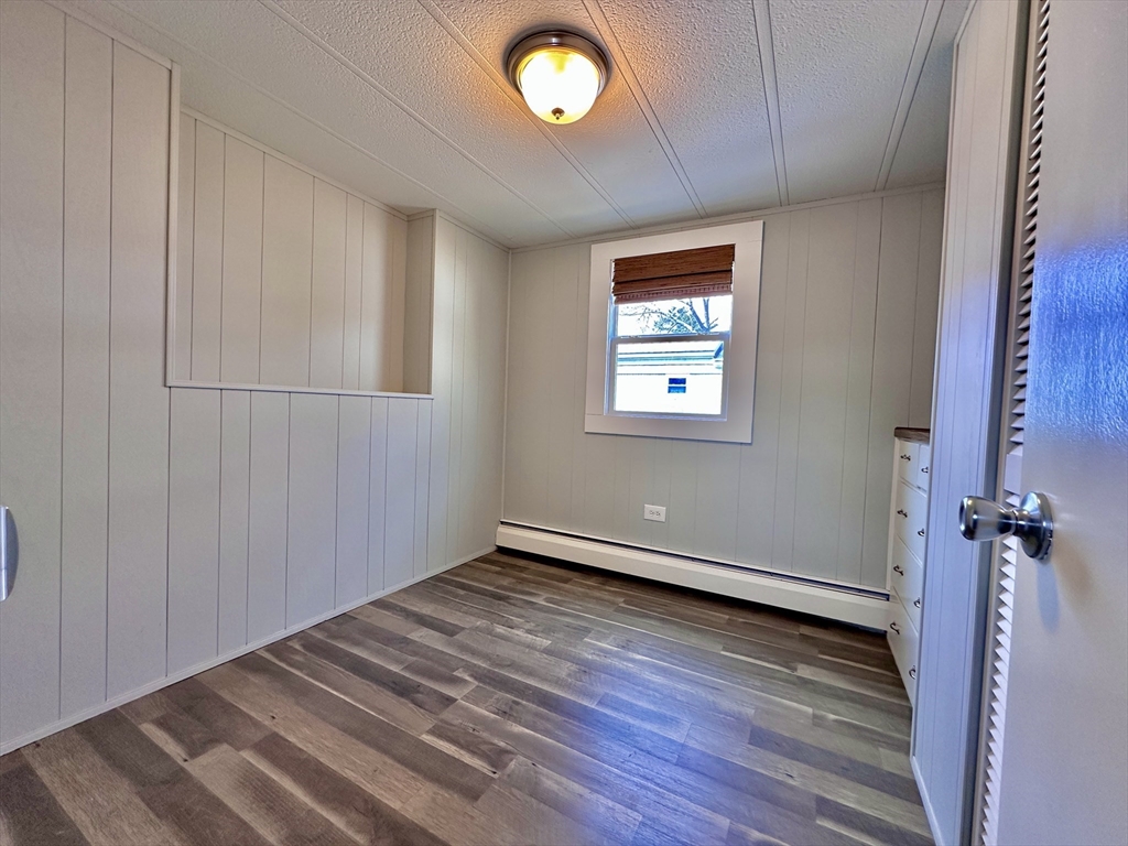 27 Windswept Road Wareham, MA 02576 - Photo 11 of 34 a view of an empty room with a window and wooden floor
