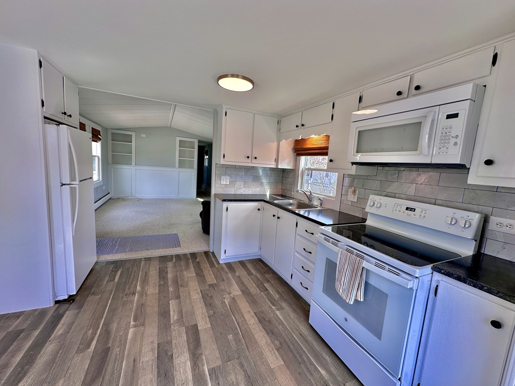 27 Windswept Road Wareham, MA 02576 - Photo 13 of 34 a large kitchen with stainless steel appliances granite countertop a stove a sink dishwasher and a refrigerator