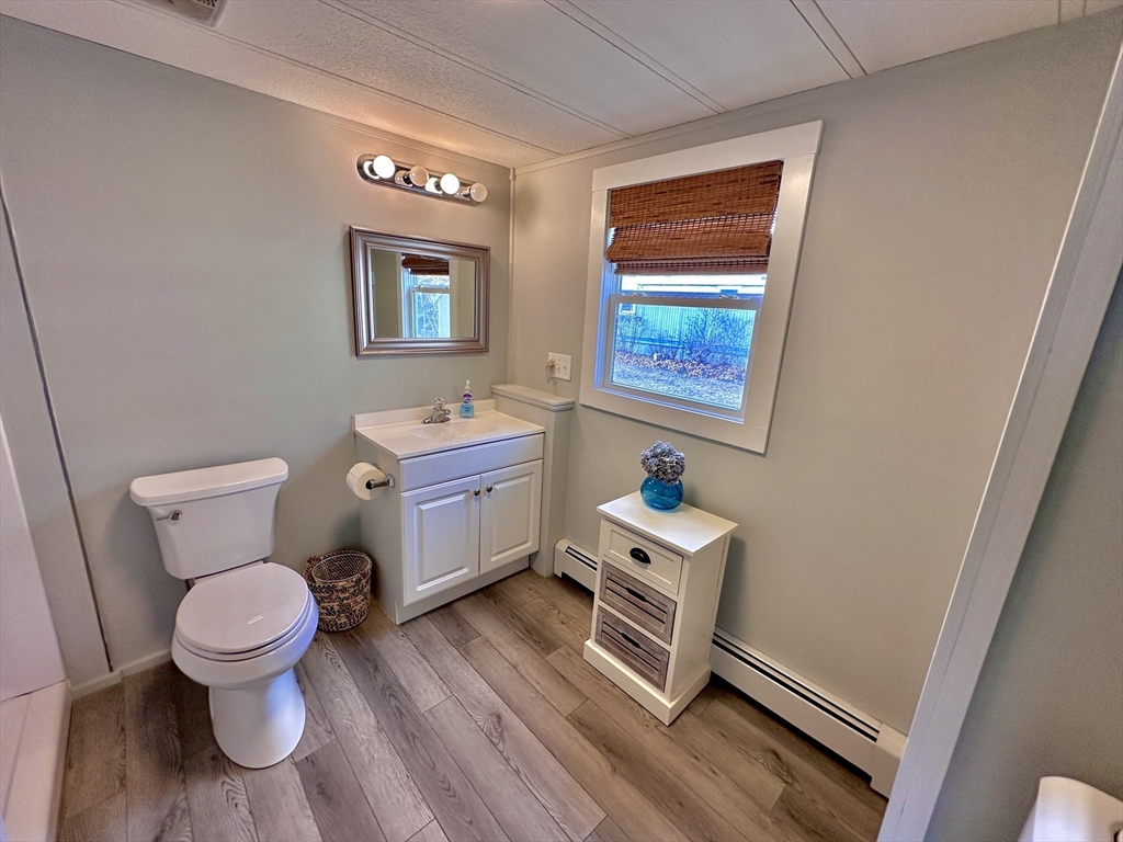 27 Windswept Road Wareham, MA 02576 - Photo 14 of 34 a bathroom with a toilet sink and mirror
