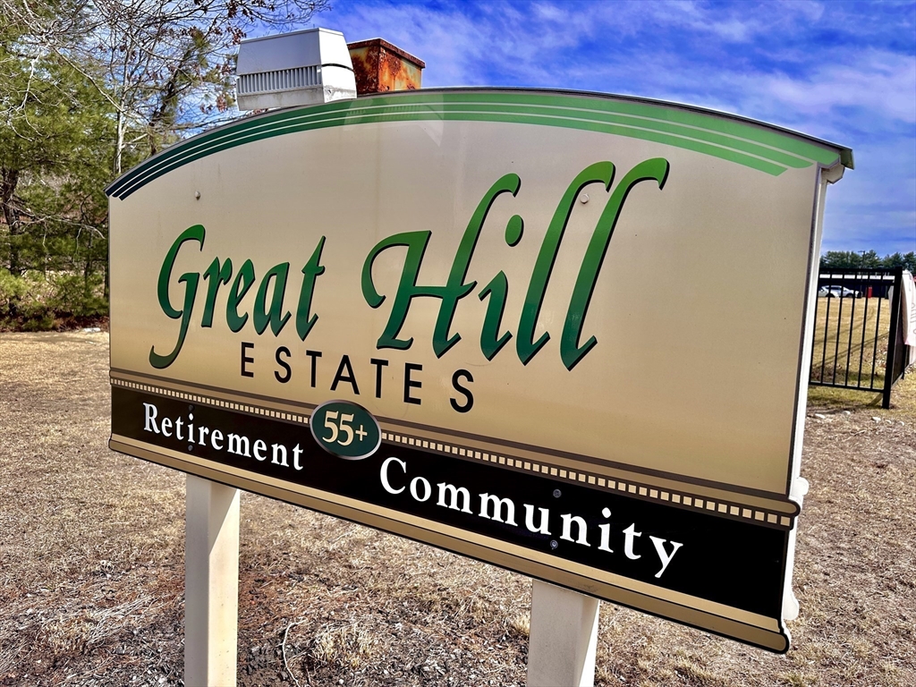 27 Windswept Road Wareham, MA 02576 - Photo 28 of 34 a street sign on a wall with building in the background