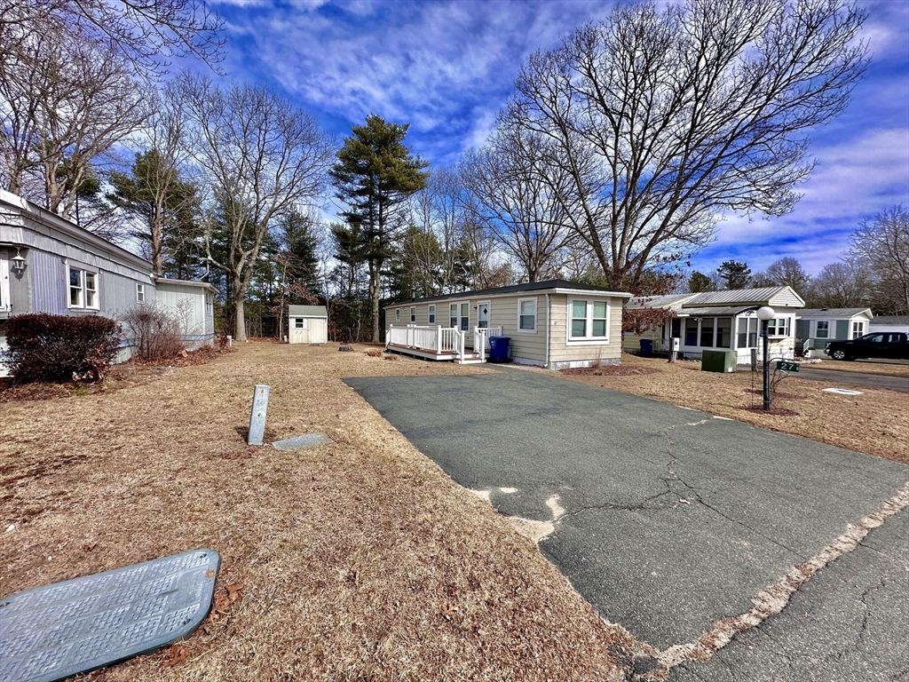 27 Windswept Road Wareham, MA 02576 - Photo 29 of 34 a view of a white house with a yard covered in snow