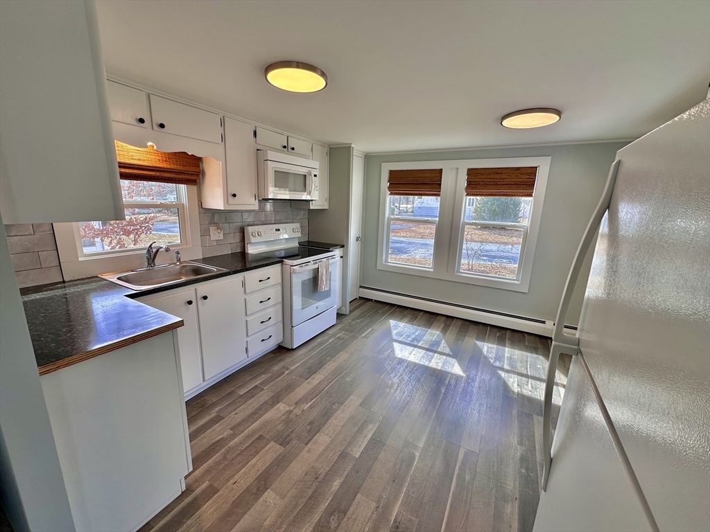 27 Windswept Road Wareham, MA 02576 - Photo 7 of 34 a kitchen with granite countertop a sink cabinets and wooden floor