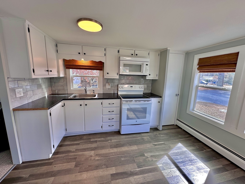 27 Windswept Road Wareham, MA 02576 - Photo 8 of 34 a kitchen with cabinets a stove and a window