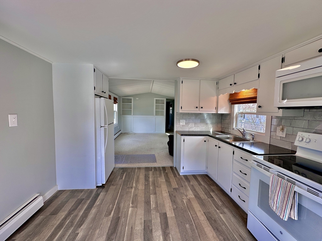 27 Windswept Road Wareham, MA 02576 - Photo 9 of 34 a kitchen with granite countertop a refrigerator and a sink
