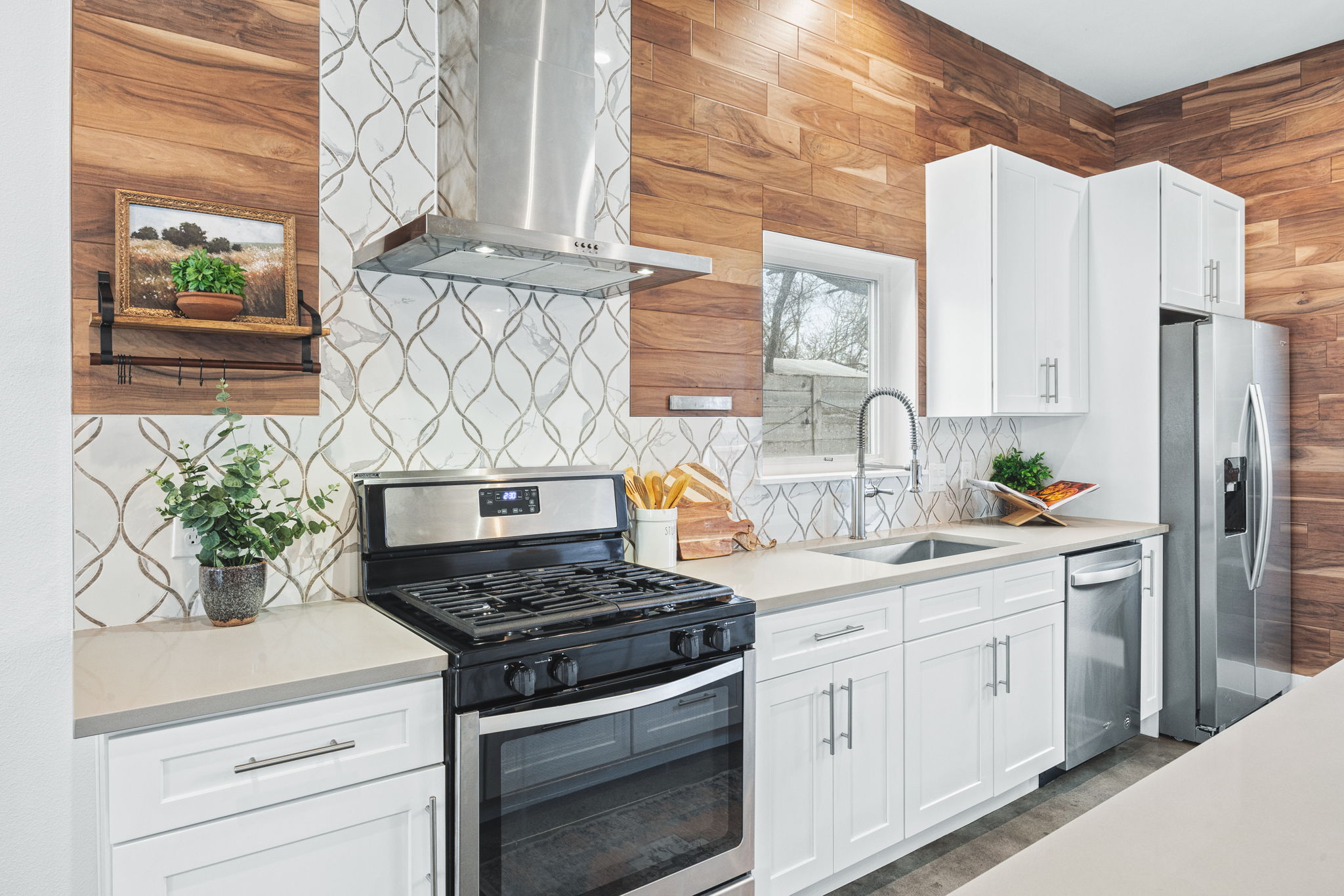 1218 Eleanor Street, Unit 1 Austin, TX 78721 - Photo 13 of 39 a kitchen with stainless steel appliances white cabinets and a stove top oven