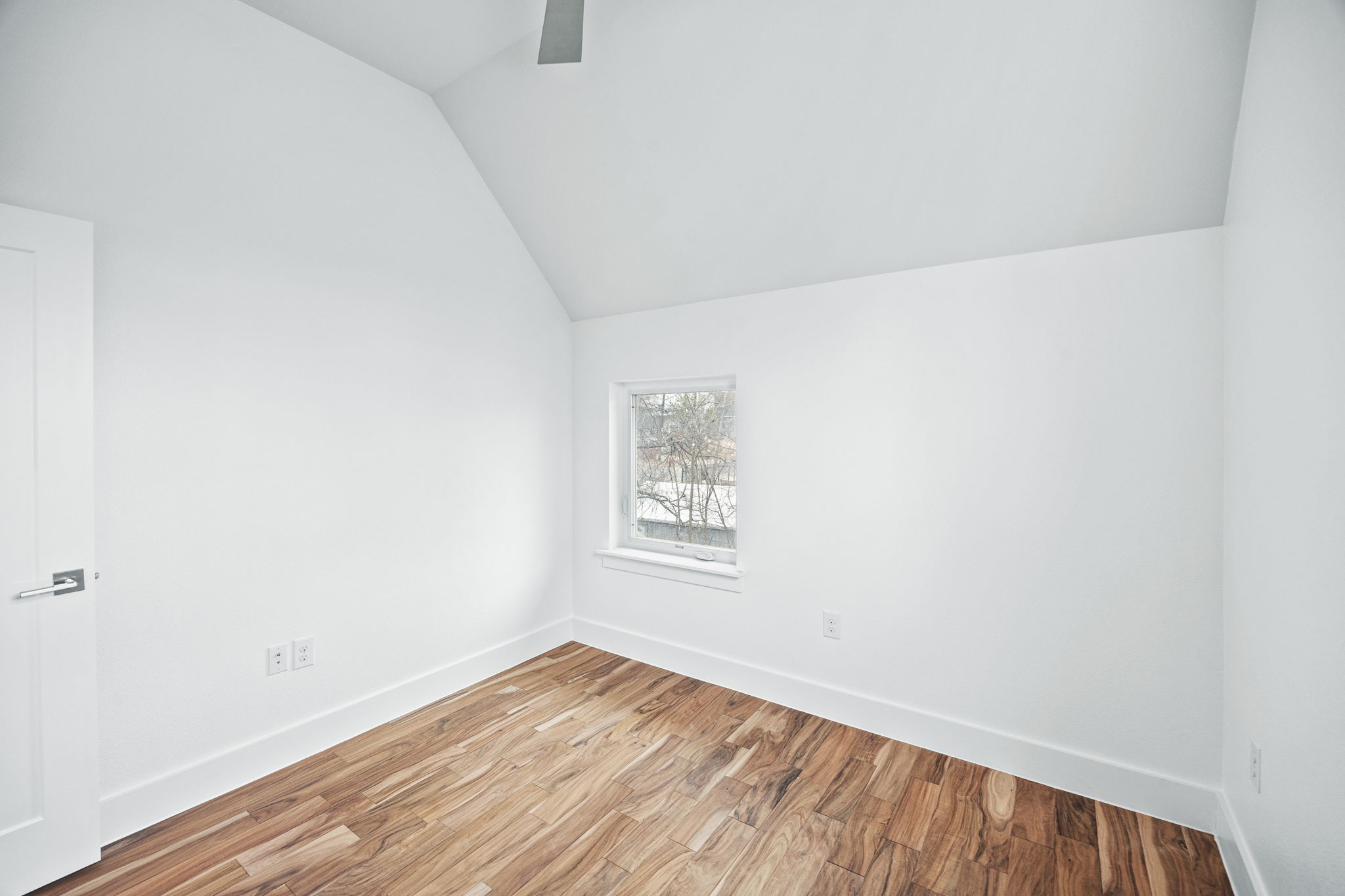 1218 Eleanor Street, Unit 1 Austin, TX 78721 - Photo 33 of 39 a view of an empty room with window and wooden floor