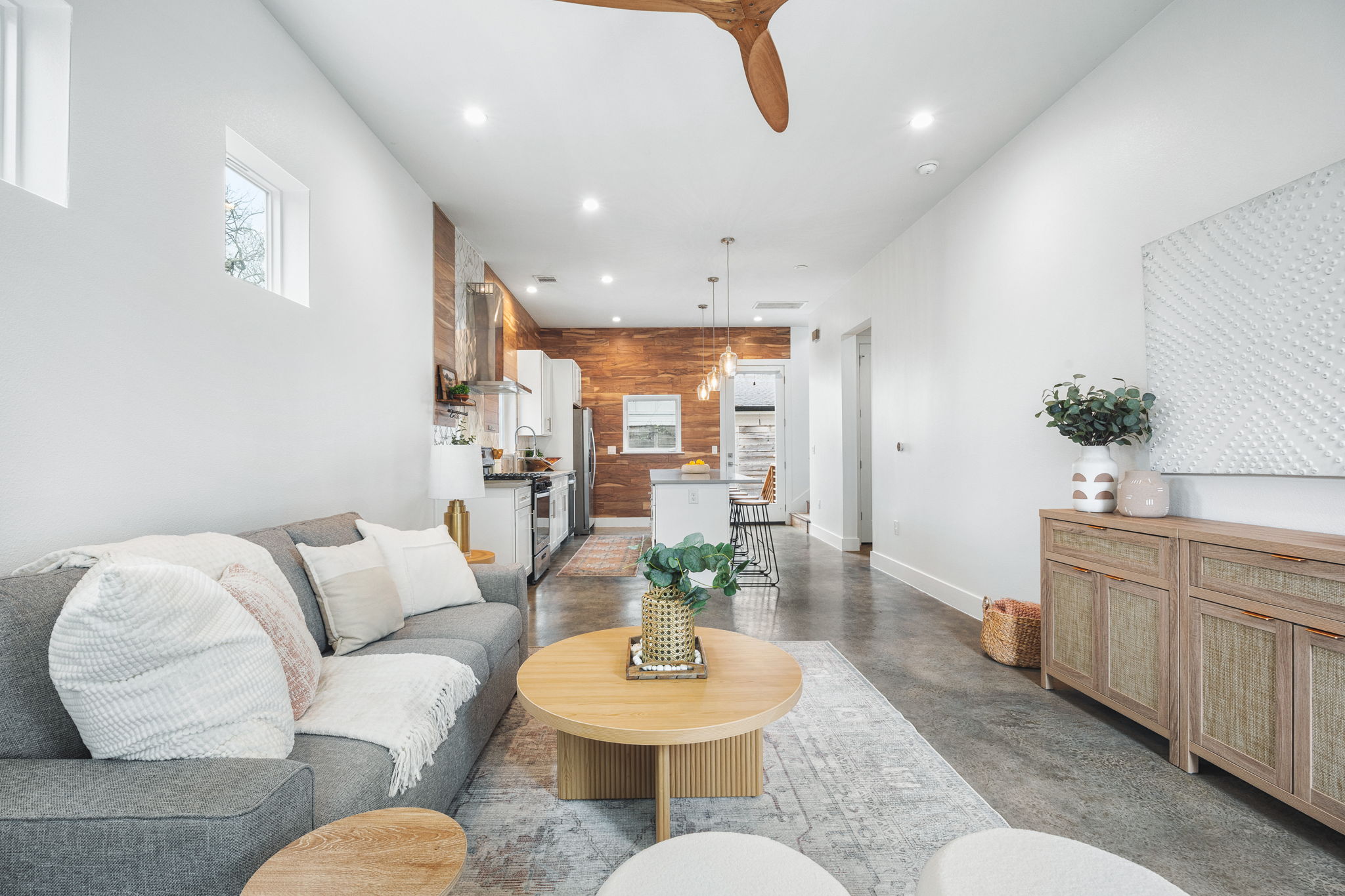 1218 Eleanor Street, Unit 1 Austin, TX 78721 - Photo 4 of 39 a living room with furniture and a dining table with kitchen view