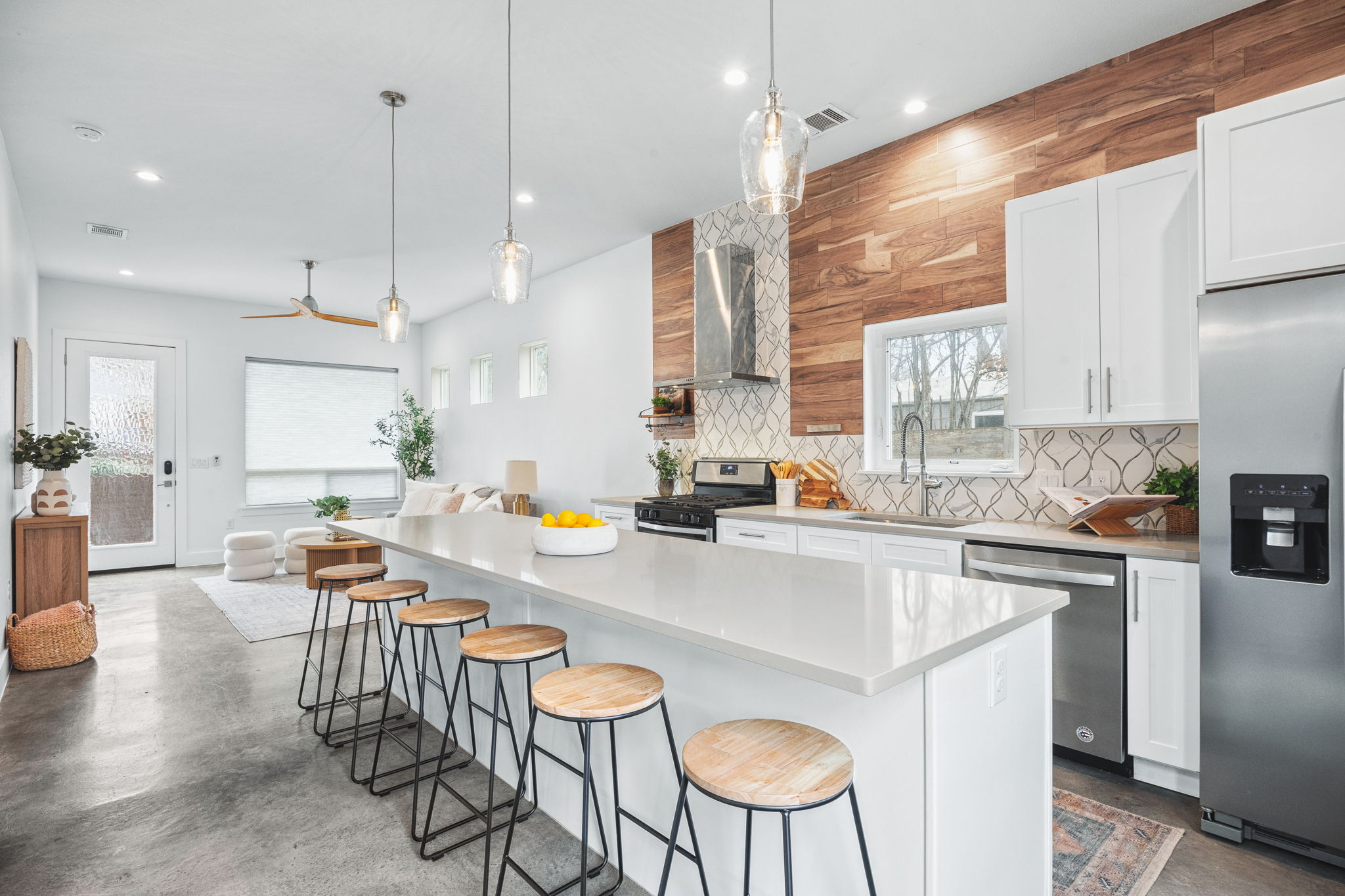 1218 Eleanor Street, Unit 1 Austin, TX 78721 - Photo 10 of 39 a kitchen with stainless steel appliances granite countertop a stove a sink a kitchen island with chairs and white cabinets