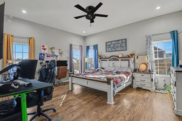 a bedroom with furniture and wooden floor