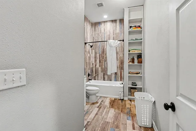 a bathroom with a toilet and a shower