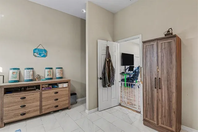 a view of a bedroom with a dresser and mirror