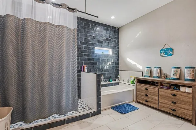 a bathroom with a bathtub and a shower