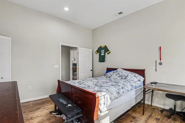 a bedroom with a bed and a dresser in it