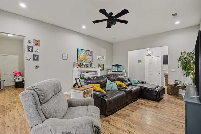 a living room with furniture and a wooden floor