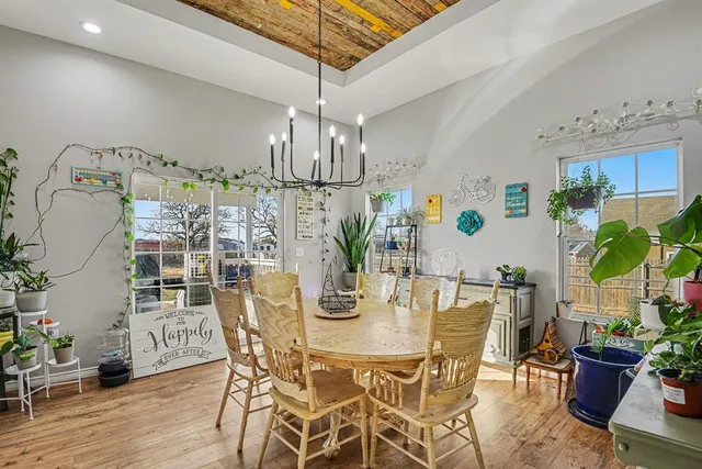 a view of a dining room with furniture and chandelier
