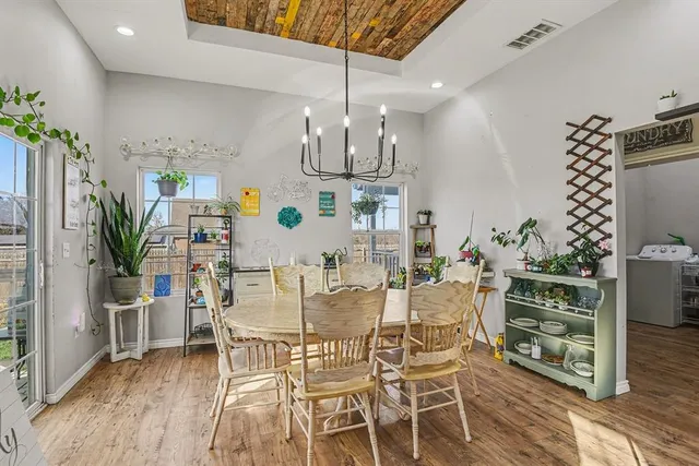 a view of a dining room with furniture and wooden floor