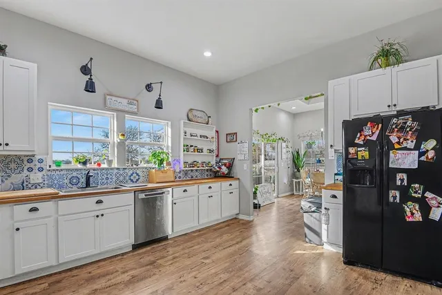 a kitchen with cabinets a sink and wooden floor