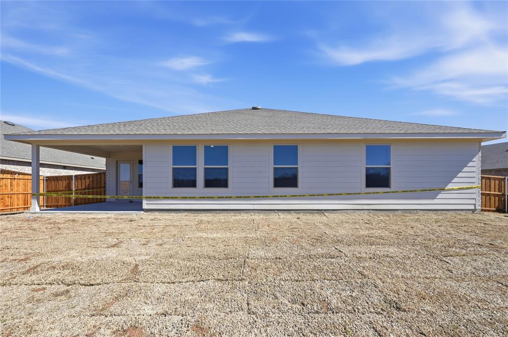 1917 Reveille Way Terrell, TX 75160 - Photo 6 of 6 Rear exterior featuring a covered patio, neutral siding, multiple windows, a shingled roof, and a privacy fence