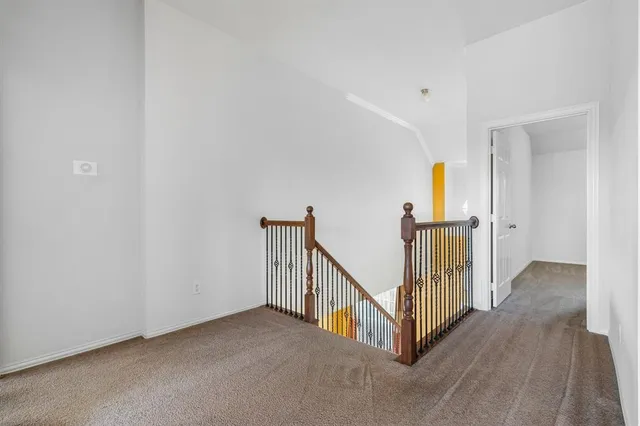 a view of a big room with wooden floor and windows