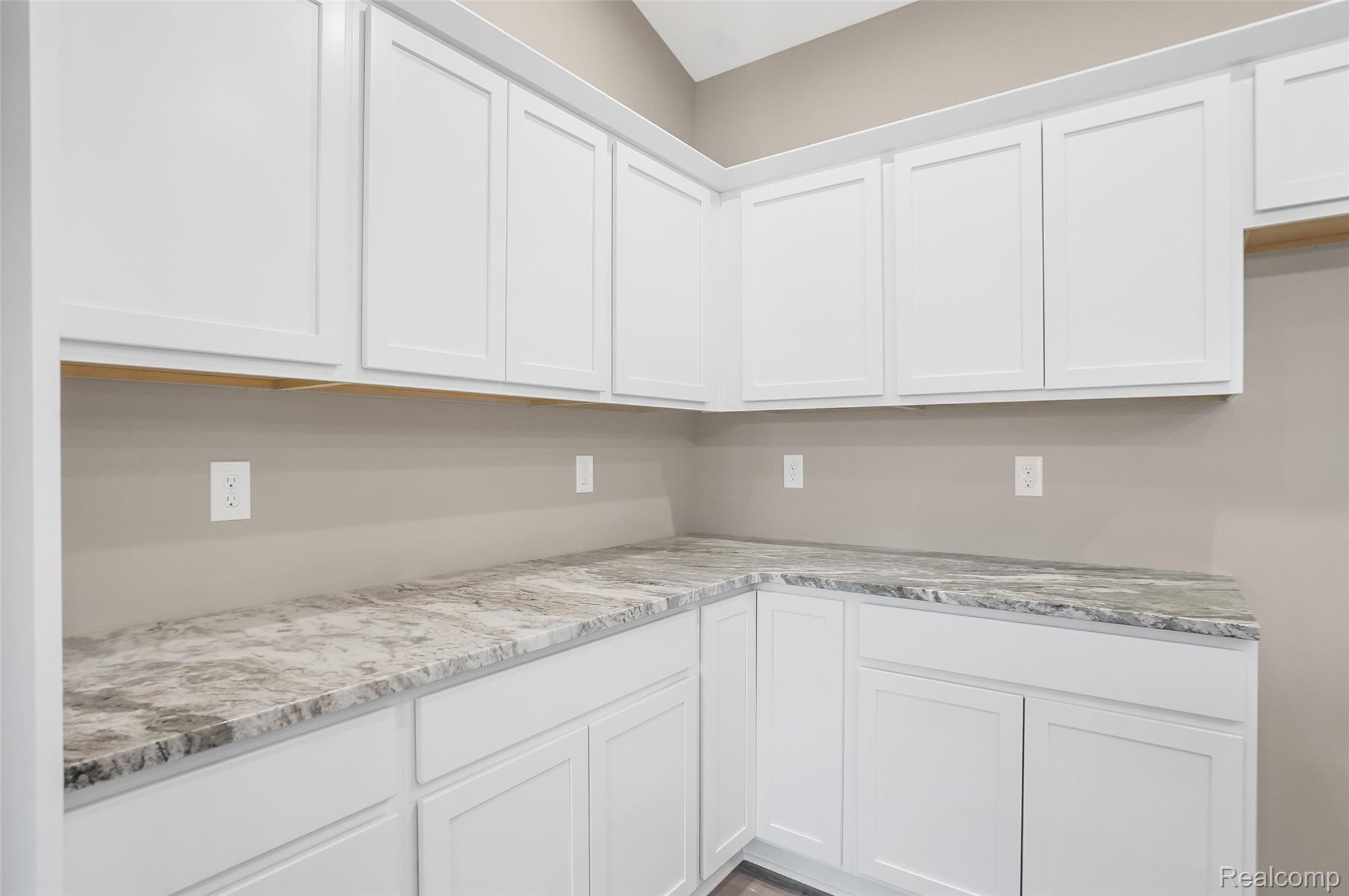 9033 Copper Ridge Drive Davison, MI 48423 - Photo 9 of 29 Kitchen with white cabinets and light stone counters