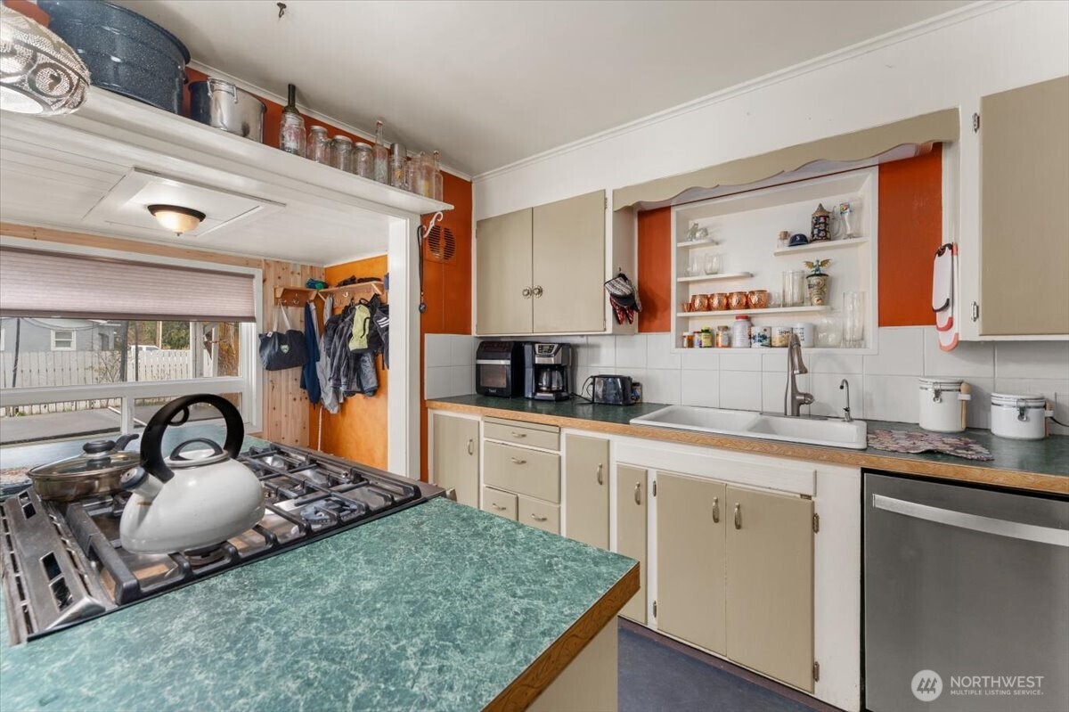 225 South Division Street Cashmere, WA 98815 - Photo 11 of 40 a kitchen with a stove a sink and a refrigerator