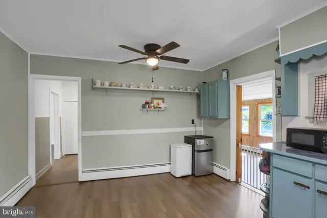 a view of a kitchen with a sink and a refrigerator