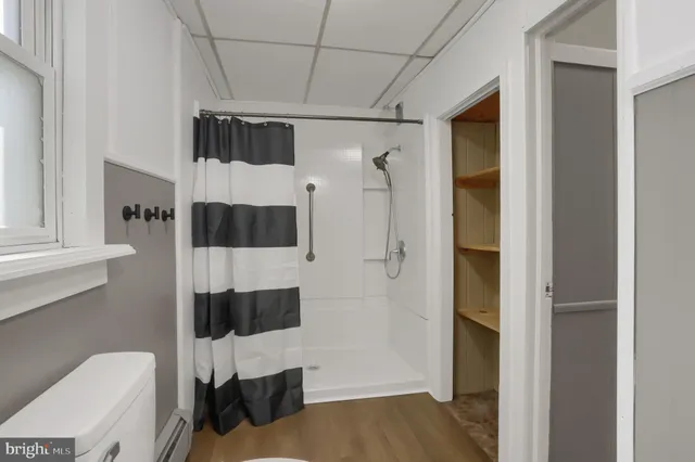 a bathroom with a toilet a sink and shower