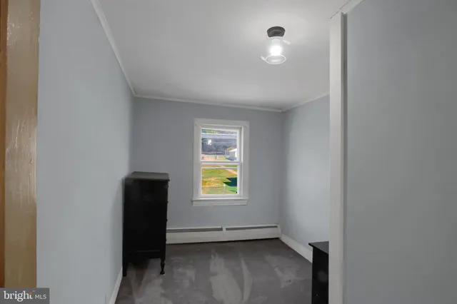 an empty room with window and closet