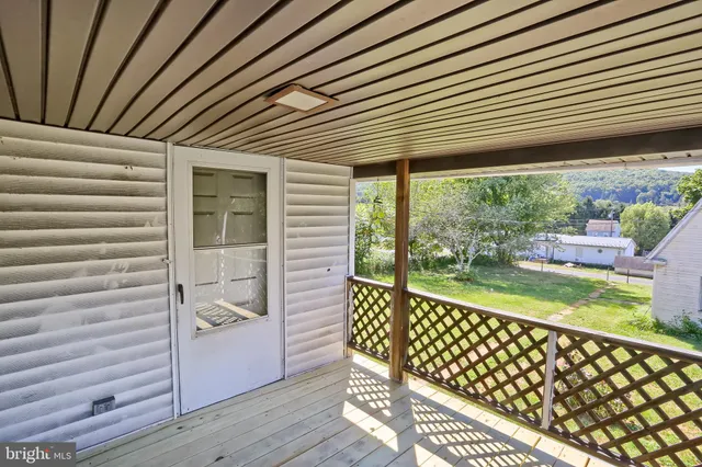 a view of a porch with wooden floor