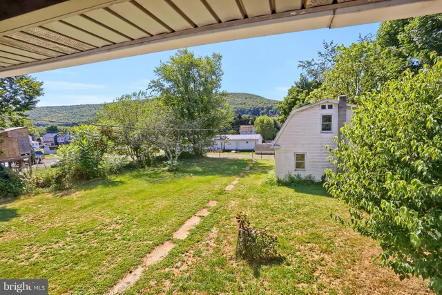 a house view with swimming pool in front of it