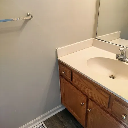 a white toilet sitting next to a white wall