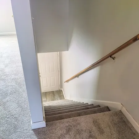 an empty room with a chandelier fan