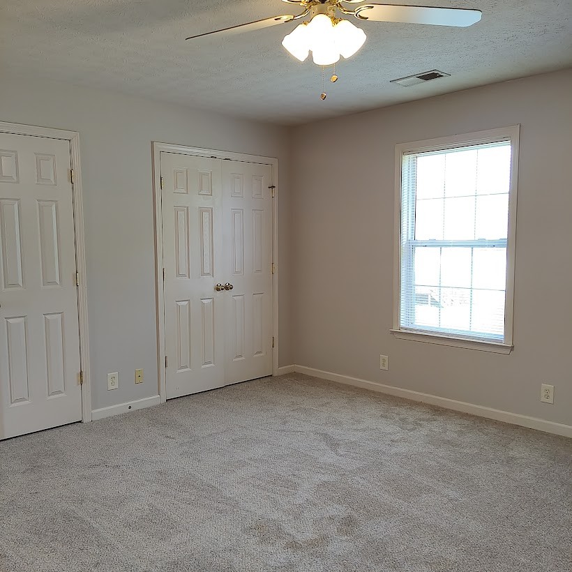 110 Mason Street Portland, TN 37148 - Photo 15 of 24 an empty room with a chandelier fan
