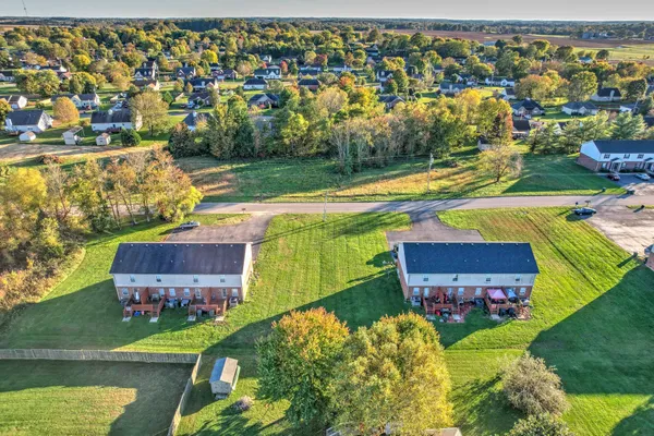 an aerial view of a house with a yard and lake view