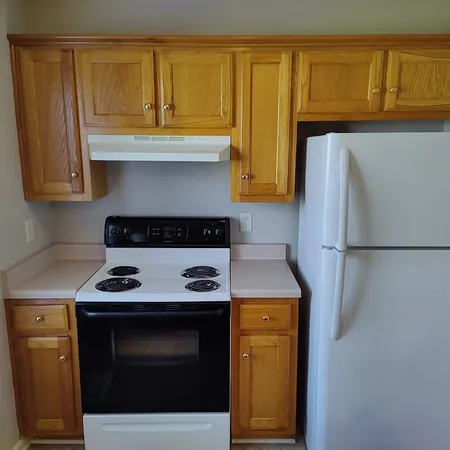 a white refrigerator freezer sitting in a kitchen