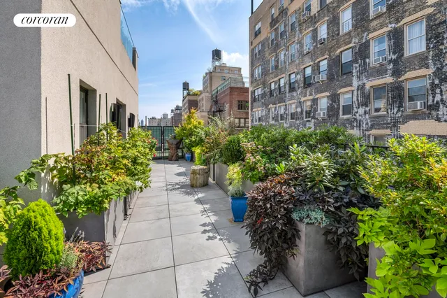 a lots of potted plants in front of a building