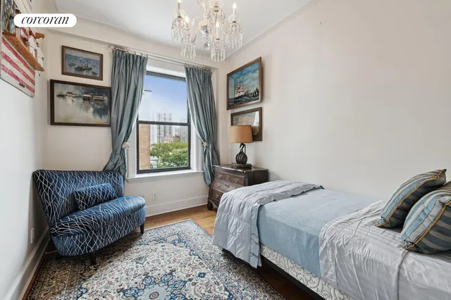 a bedroom with a bed couch and window