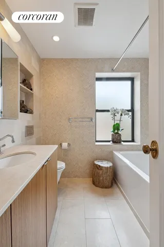 a spacious bathroom with a bathtub sink and toilet