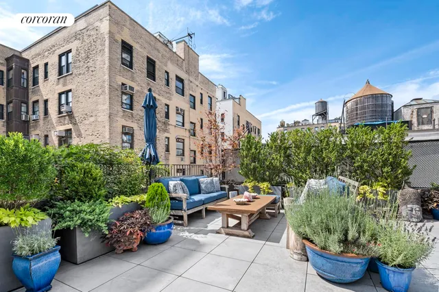 a view of a patio filled with furniture and plants