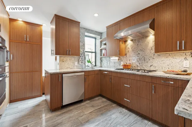 a kitchen with granite countertop wooden cabinets and white appliances