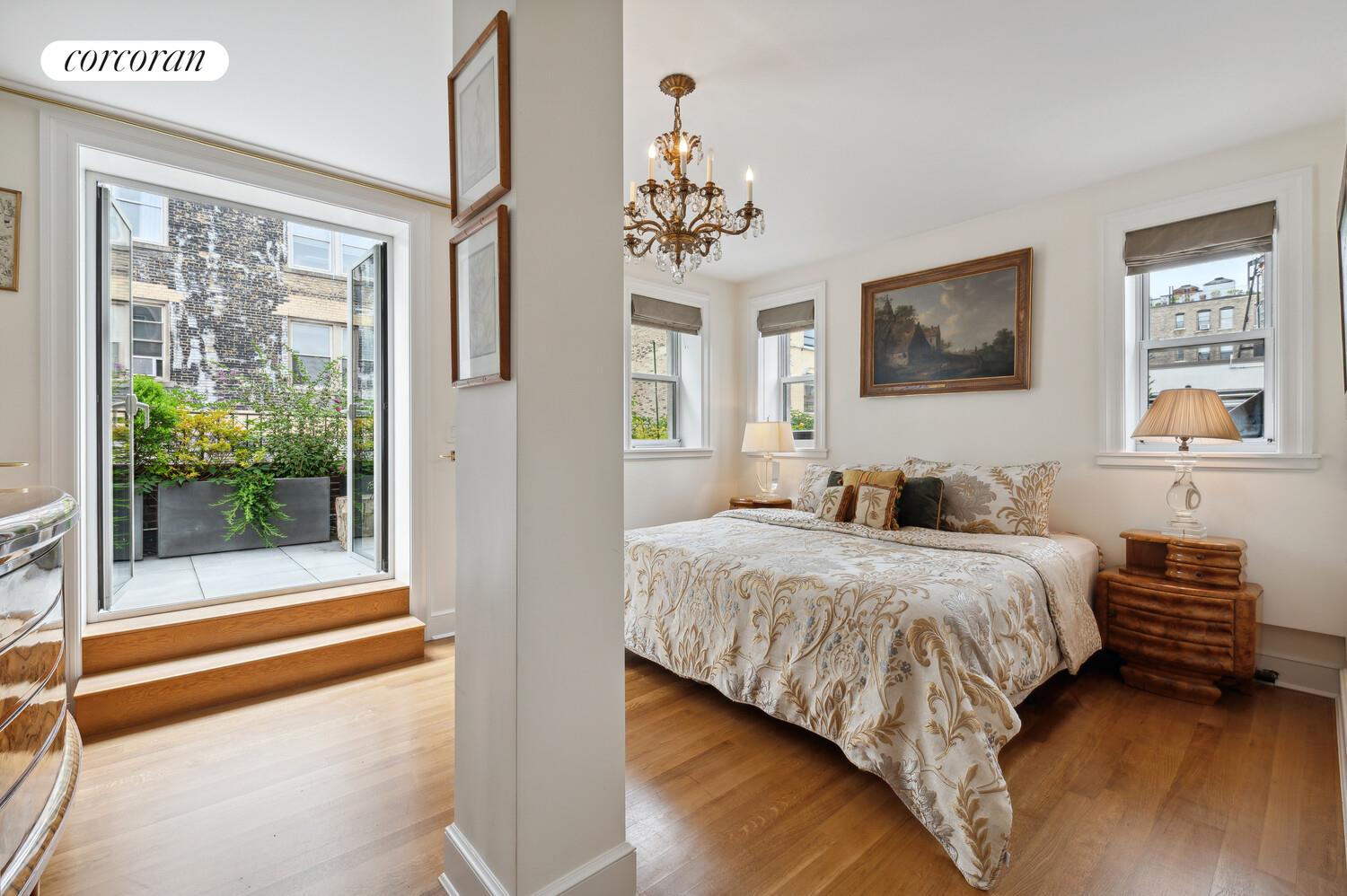 150 West 87th Street, Unit PHS Manhattan, NY 10024 - Photo 6 of 16 a bedroom with a bed and a chandelier