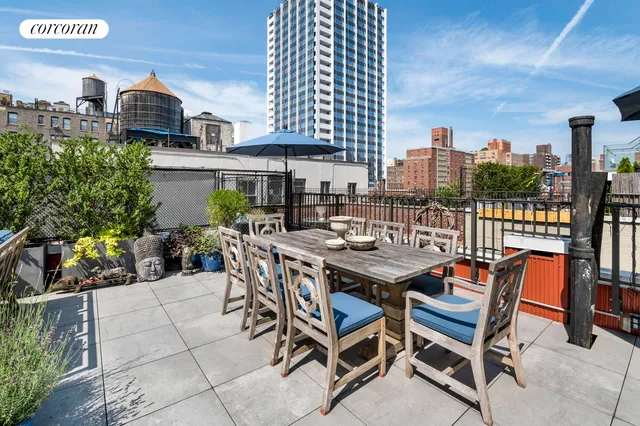 a view of a patio with table and chairs and potted plants