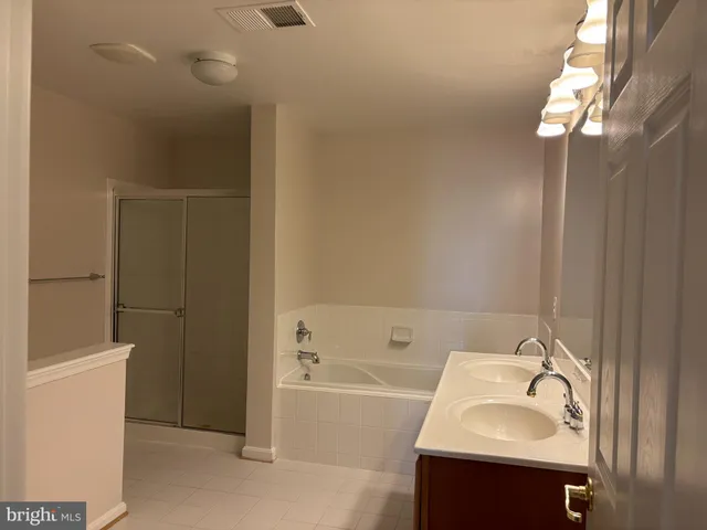 a bathroom with a sink a bathtub and a shower