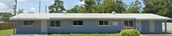 a house with a yard and potted plants