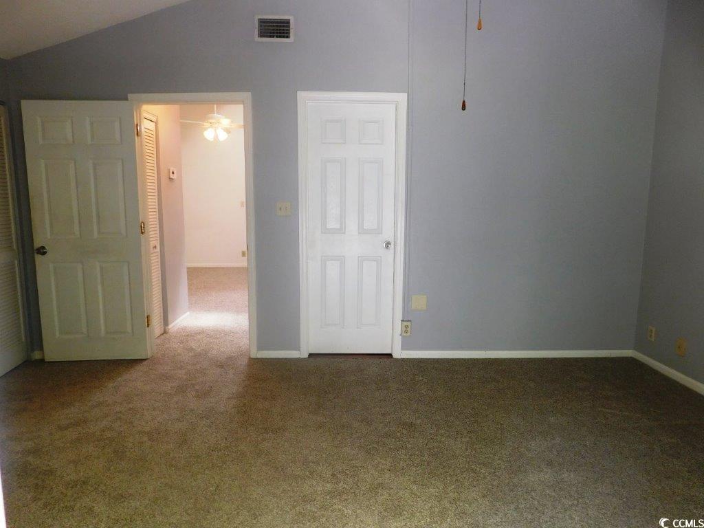 1202 Tiffany Lane, Unit D Myrtle Beach, SC 29577 - Photo 12 of 21 Carpeted empty room with ceiling fan and lofted ceiling